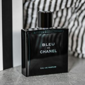Luxurious Bleu de Chanel perfume bottle showcased with stylish backdrop for product photography.